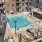 Drone shot of pool deck with outdoor seating and gas grill